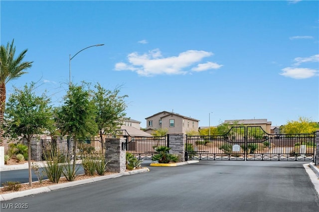 3729 Canis Minor Ln Unit 10206, Henderson, NV 89052 - view of asphalt road with a gate, curbs, street lights, and a gated entry