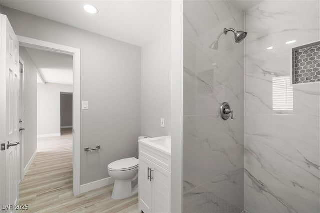 5817 Glen Eagles Ln, Las Vegas, NV 89108 - bathroom with a marble finish shower, toilet, vanity, wood finished floors, and recessed lighting