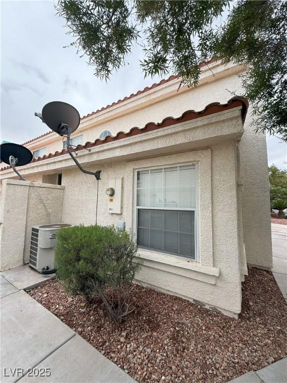 7969 Cina Ave, Las Vegas, NV 89147 - view of side of property with central air condition unit and stucco siding