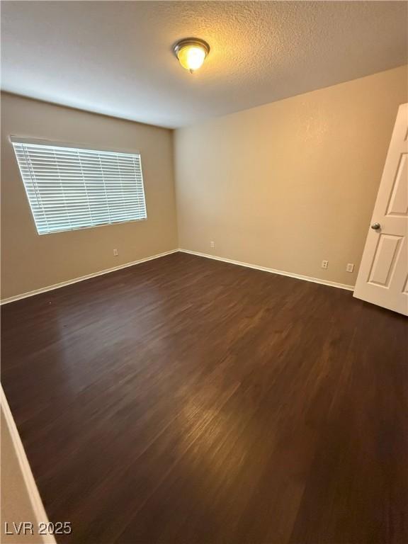 7969 Cina Ave, Las Vegas, NV 89147 - unfurnished room featuring dark wood-style flooring and baseboards