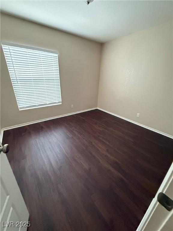 7969 Cina Ave, Las Vegas, NV 89147 - empty room with dark wood-type flooring and baseboards