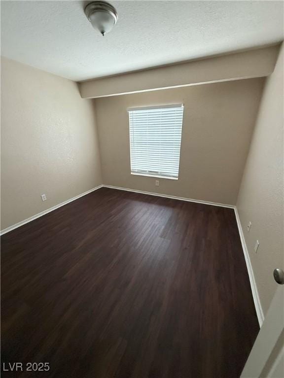 7969 Cina Ave, Las Vegas, NV 89147 - spare room featuring dark wood-style flooring and baseboards
