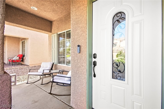 7641 Lani Dawn St, Las Vegas, NV 89149 - doorway to property featuring covered porch and stucco siding