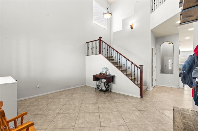 7641 Lani Dawn St, Las Vegas, NV 89149 - foyer entrance featuring a towering ceiling, stairs, tile patterned flooring, and baseboards