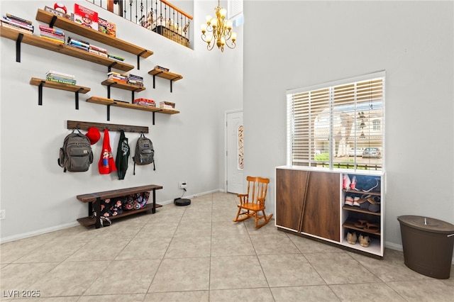 7641 Lani Dawn St, Las Vegas, NV 89149 - foyer featuring baseboards, a high ceiling, tile patterned floors, and a chandelier