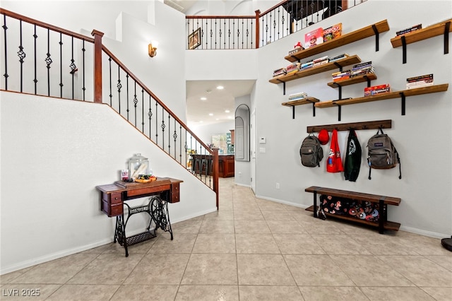 7641 Lani Dawn St, Las Vegas, NV 89149 - entrance foyer with a high ceiling, stairs, tile patterned flooring, and baseboards