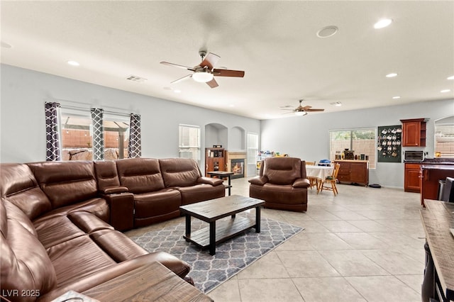 7641 Lani Dawn St, Las Vegas, NV 89149 - living room with ceiling fan, light tile patterned floors, recessed lighting, and arched walkways