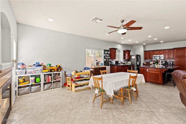 7641 Lani Dawn St, Las Vegas, NV 89149 - dining room with ceiling fan, recessed lighting, and light tile patterned floors