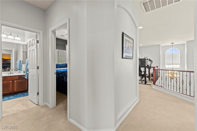 7641 Lani Dawn St, Las Vegas, NV 89149 - hall with light carpet, a chandelier, and baseboards