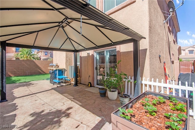 7641 Lani Dawn St, Las Vegas, NV 89149 - view of patio / terrace with a gazebo, fence, and a garden