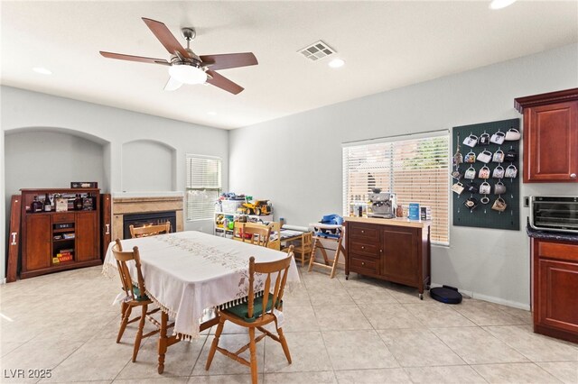 7641 Lani Dawn St, Las Vegas, NV 89149 - dining room featuring a warm lit fireplace, healthy amount of natural light, a ceiling fan, recessed lighting, and light tile patterned flooring