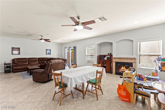 7641 Lani Dawn St, Las Vegas, NV 89149 - dining area with a glass covered fireplace, light tile patterned flooring, a ceiling fan, and recessed lighting