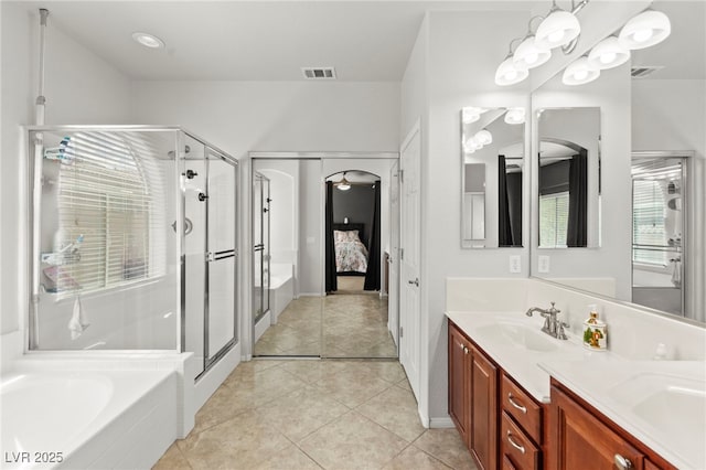 7641 Lani Dawn St, Las Vegas, NV 89149 - ensuite bathroom with a stall shower, double vanity, tile patterned floors, and a bath