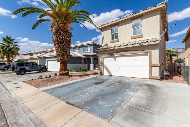 1360 Angel Falls St, Las Vegas, NV 89142 - mediterranean / spanish-style house with stucco siding, concrete driveway, an attached garage, and a tile roof