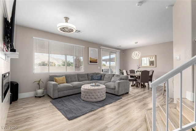 1360 Angel Falls St, Las Vegas, NV 89142 - living area featuring light wood-type flooring, baseboards, and a tile fireplace
