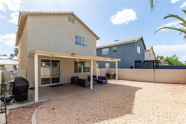 1360 Angel Falls St, Las Vegas, NV 89142 - rear view of property featuring stucco siding, a fenced backyard, a patio area, and an outdoor living space