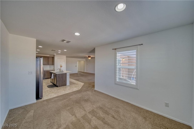 5460 Chippewa, Pahrump, NV 89061 - unfurnished living room featuring light colored carpet, recessed lighting, ceiling fan, a sink, and baseboards