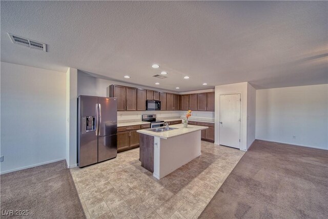 5460 Chippewa, Pahrump, NV 89061 - kitchen with appliances with stainless steel finishes, light countertops, recessed lighting, a kitchen island with sink, and light colored carpet