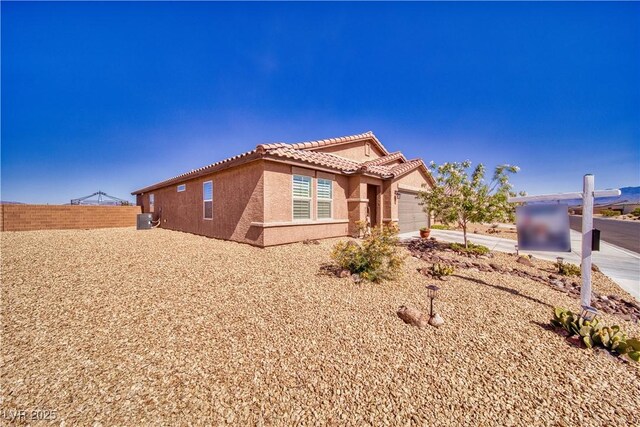 5460 Chippewa, Pahrump, NV 89061 - single story home with a tiled roof, stucco siding, a garage, and central AC unit