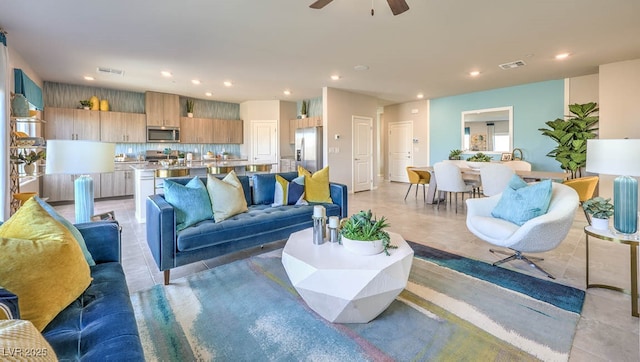 living area with recessed lighting and a ceiling fan