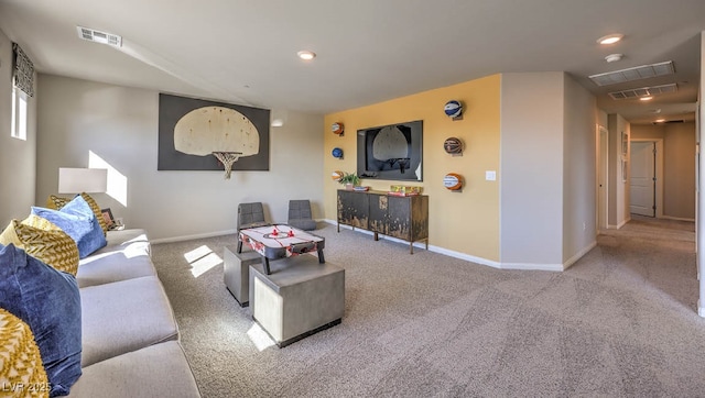 carpeted living area featuring baseboards and recessed lighting