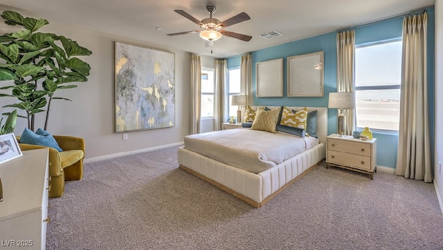 bedroom featuring multiple windows, carpet flooring, baseboards, and a ceiling fan