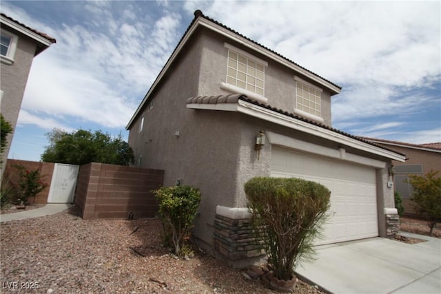 3440 Crystal Tower St, Las Vegas, NV 89129 - view of side of home with stucco siding, an attached garage, driveway, fence, and a tile roof