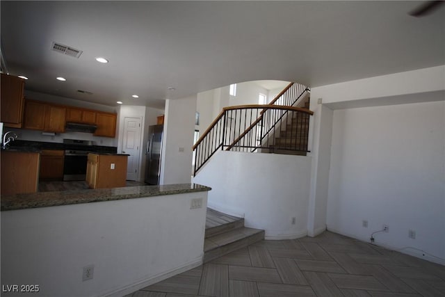 3440 Crystal Tower St, Las Vegas, NV 89129 - kitchen featuring appliances with stainless steel finishes, under cabinet range hood, baseboards, recessed lighting, and brown cabinets