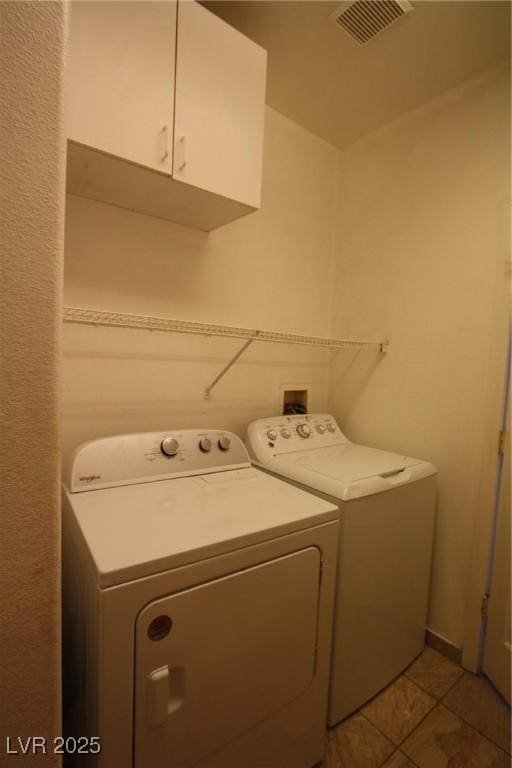 3440 Crystal Tower St, Las Vegas, NV 89129 - clothes washing area featuring washer and dryer, cabinet space, and light tile patterned floors