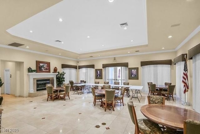 3440 Crystal Tower St, Las Vegas, NV 89129 - dining area with a tray ceiling, a glass covered fireplace, crown molding, light tile patterned floors, and recessed lighting