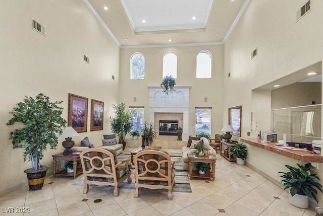3440 Crystal Tower St, Las Vegas, NV 89129 - living area featuring light tile patterned floors, a high ceiling, recessed lighting, a fireplace, and ornamental molding