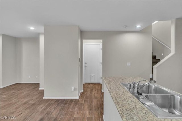 7632 Calico Fields St, Las Vegas, NV 89149 - kitchen with a sink, dark wood-type flooring, light countertops, recessed lighting, and baseboards