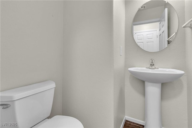 7632 Calico Fields St, Las Vegas, NV 89149 - half bath with toilet, a sink, and baseboards