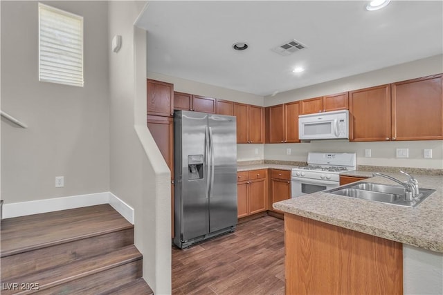 7632 Calico Fields St, Las Vegas, NV 89149 - kitchen with white appliances, a sink, light countertops, recessed lighting, and a peninsula