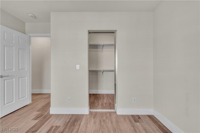 7632 Calico Fields St, Las Vegas, NV 89149 - unfurnished bedroom featuring wood finished floors, a closet, a spacious closet, and baseboards