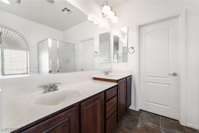 full bathroom with a stall shower, vanity, and stone finish flooring