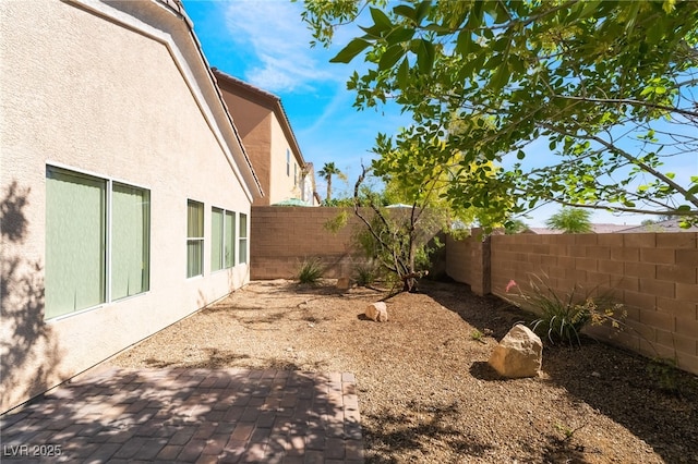 fenced backyard with a patio area