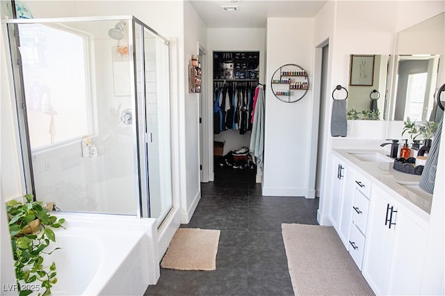 5733 Coral Sun St, North Las Vegas, NV 89031 - full bathroom with plenty of natural light, a shower stall, a garden tub, and a walk in closet