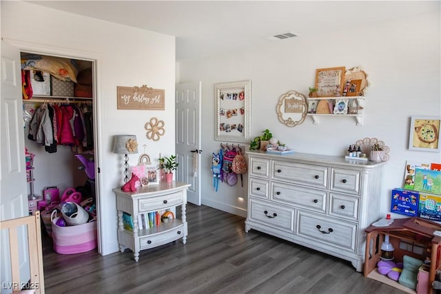 5733 Coral Sun St, North Las Vegas, NV 89031 - bedroom with dark wood-style flooring, a closet, and baseboards