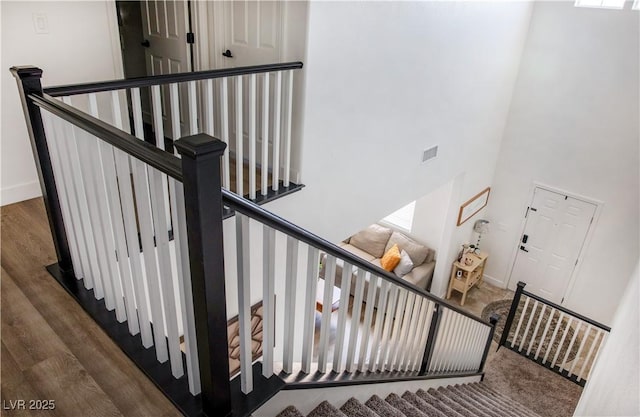 5733 Coral Sun St, North Las Vegas, NV 89031 - stairway featuring a towering ceiling, wood finished floors, baseboards, and healthy amount of natural light