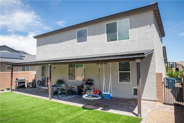 5733 Coral Sun St, North Las Vegas, NV 89031 - back of house with stucco siding, a patio, and an outdoor living space