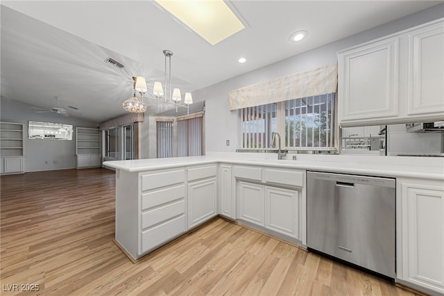 9917 Arbuckle Dr, Las Vegas, NV 89134 - kitchen featuring dishwasher, a sink, light countertops, light wood-style floors, and vaulted ceiling