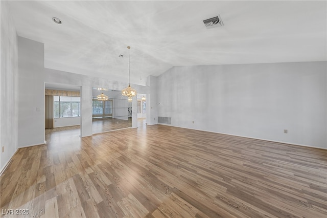 9917 Arbuckle Dr, Las Vegas, NV 89134 - unfurnished living room with a chandelier, light wood-style floors, and vaulted ceiling