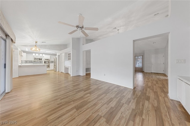 9917 Arbuckle Dr, Las Vegas, NV 89134 - unfurnished living room with a chandelier, light wood-style flooring, ceiling fan, and lofted ceiling