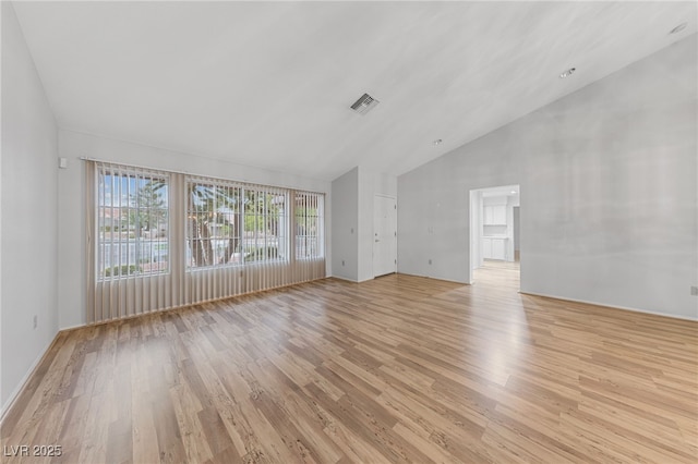 9917 Arbuckle Dr, Las Vegas, NV 89134 - unfurnished living room with light wood-type flooring and high vaulted ceiling