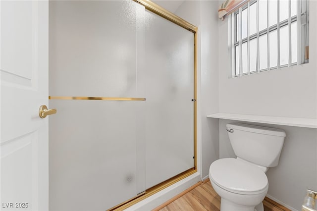9917 Arbuckle Dr, Las Vegas, NV 89134 - bathroom with wood finished floors, a stall shower, toilet, and baseboards
