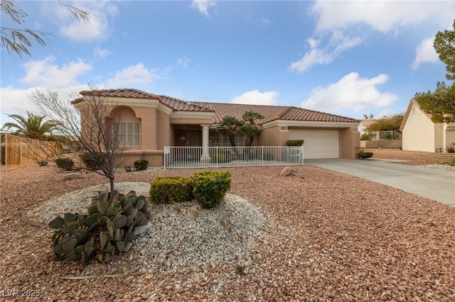 9917 Arbuckle Dr, Las Vegas, NV 89134 - mediterranean / spanish home featuring stucco siding, a tile roof, driveway, a garage, and fence