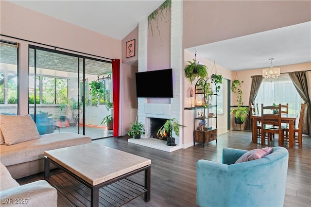 2479 Domingo St, Las Vegas, NV 89121 - living area featuring a chandelier, wood finished floors, a fireplace, and a high ceiling