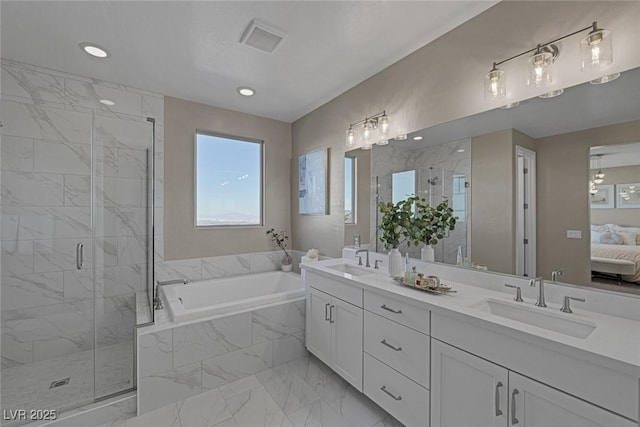 2246 Bird Of Prey St, Las Vegas, NV 89138 - ensuite bathroom featuring marble look tile flooring, a garden tub, double vanity, a marble finish shower, and recessed lighting