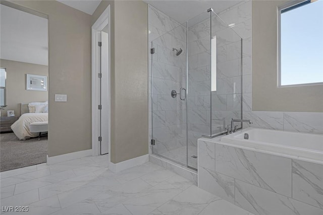 2246 Bird Of Prey St, Las Vegas, NV 89138 - ensuite bathroom featuring baseboards, a garden tub, plenty of natural light, and a marble finish shower